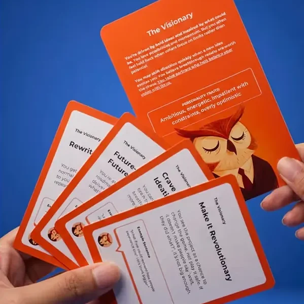 A hand fanning The Visionary persona card and its Client Action cards
