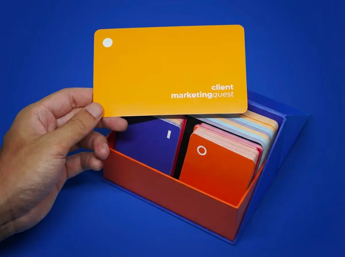 A hand lifting a quest card out of the open Client Quest box